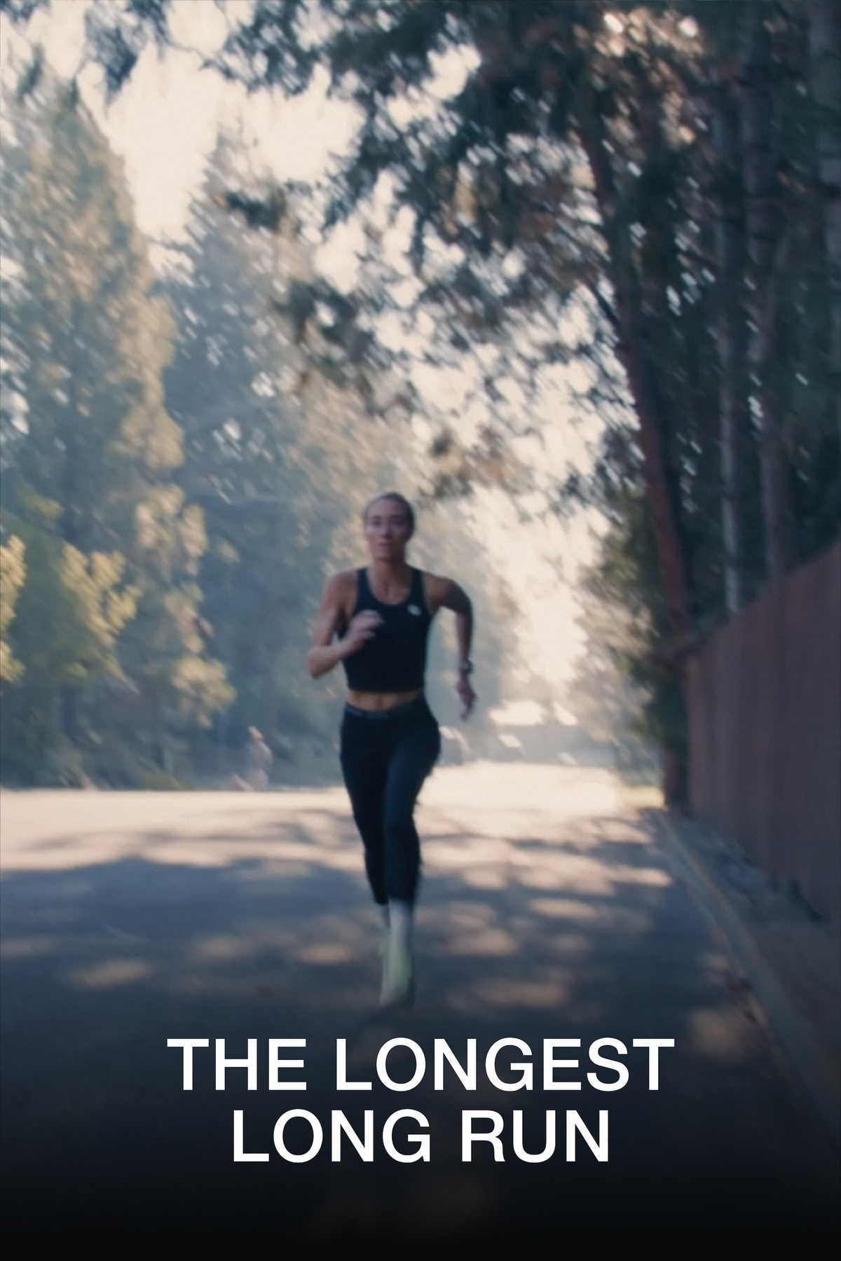 A woman running on a sunlit road surrounded by trees, with the text 'THE LONGEST LONG RUN' at the bottom.