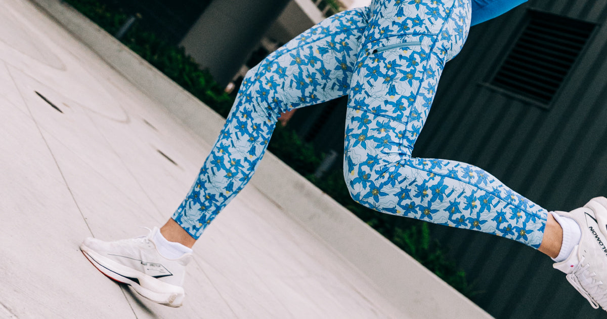 Woman running outside in Oiselle blue floral print Pockito tights