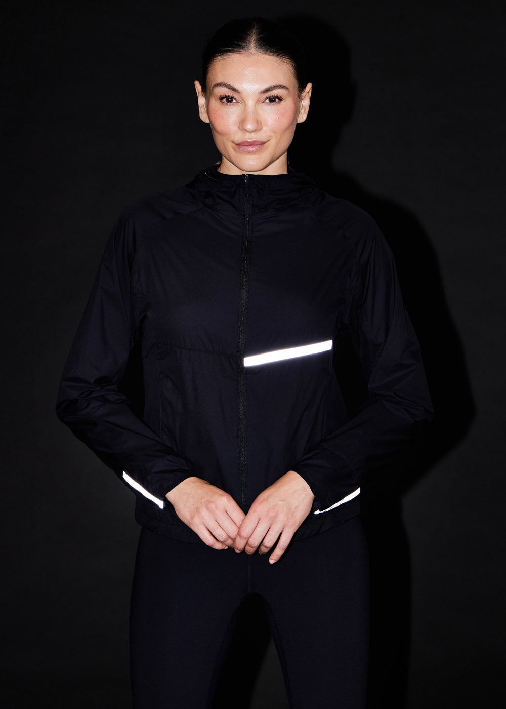 Vim Packable Running Jacket in Black, front view with reflective details
