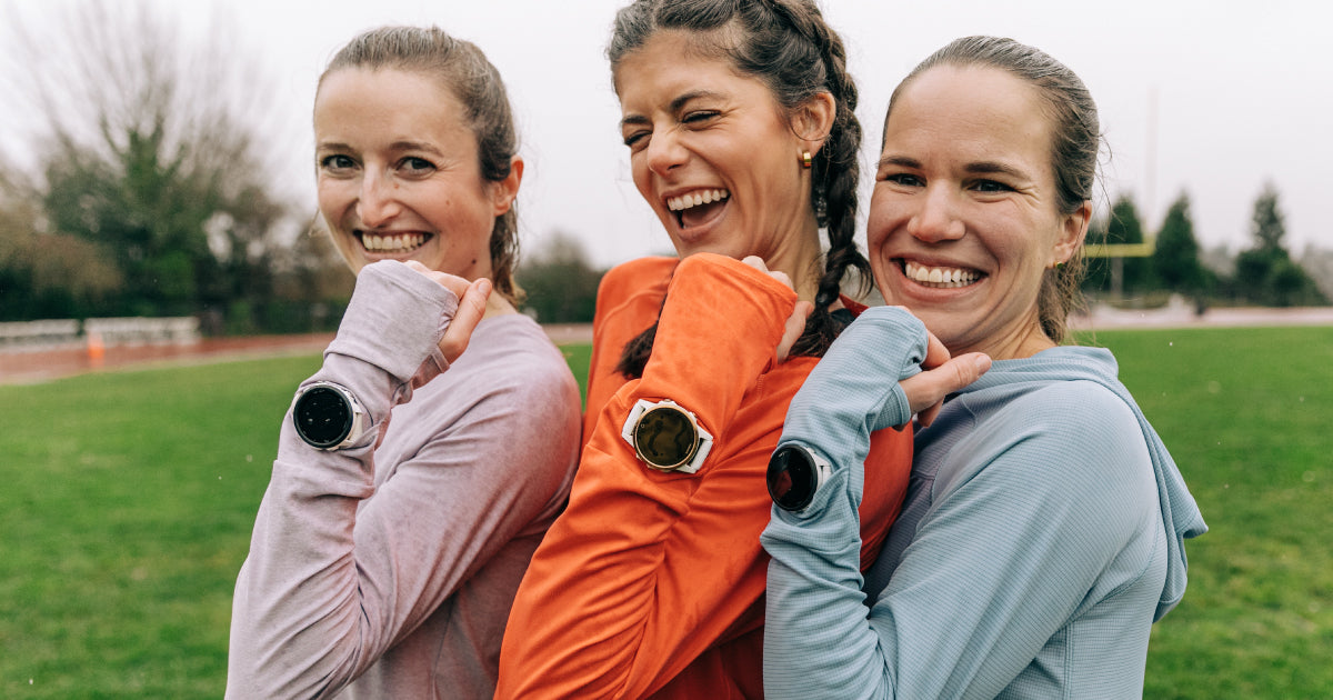 Woman showing their running watches through Oiselle Watch Window
